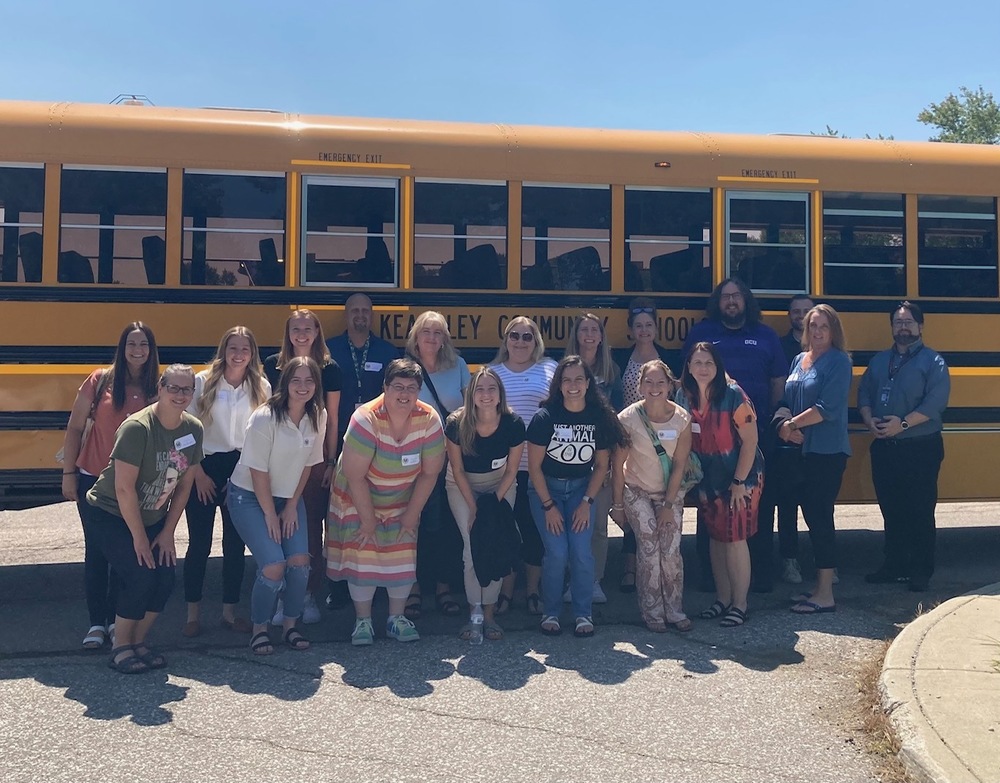 New teachers in front of a bus